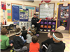 Officer McCarthy reading to elementary school students